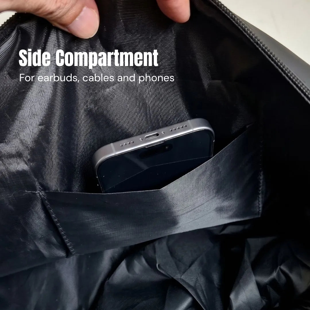 Side compartment of the GymRoam 30L Duffle Bag holding a phone, sized for earbuds and cables