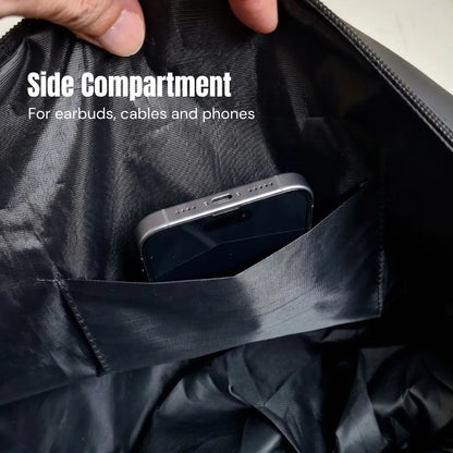 Side compartment of the GymRoam 30L Duffle Bag holding a phone, sized for earbuds and cables