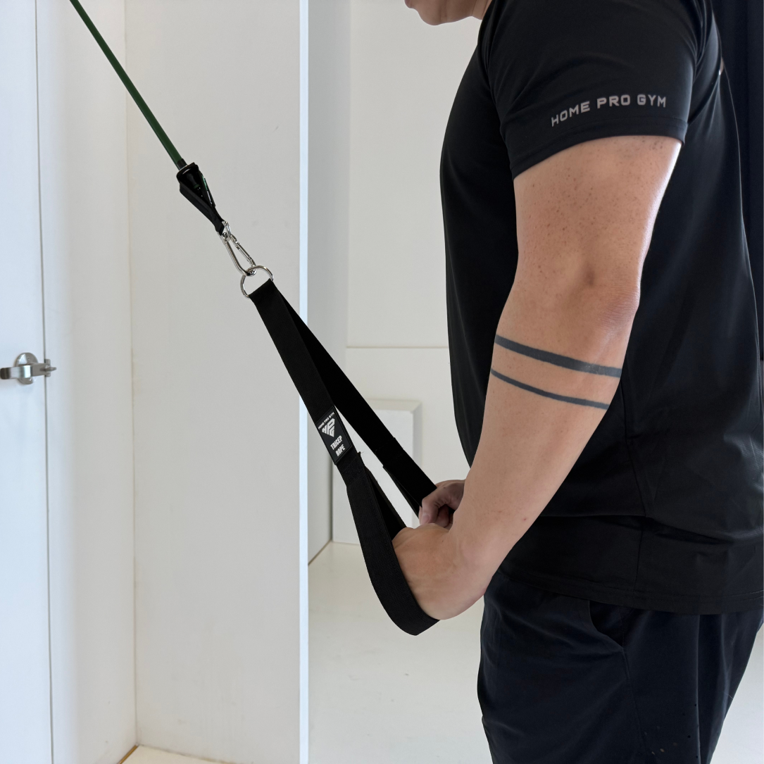 Man doing a tricep pushdown with the LiteRope Foldable Tricep Rope clipped to HomeProGym Resistance Bands on a door anchor