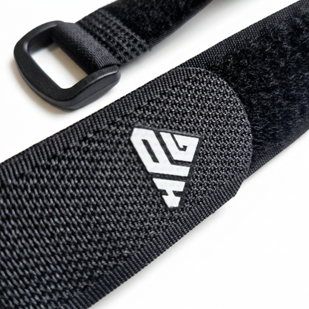 Close-up of a Clinch Band Storage Strap showing the hook and loop surface and the plastic buckle loop end
