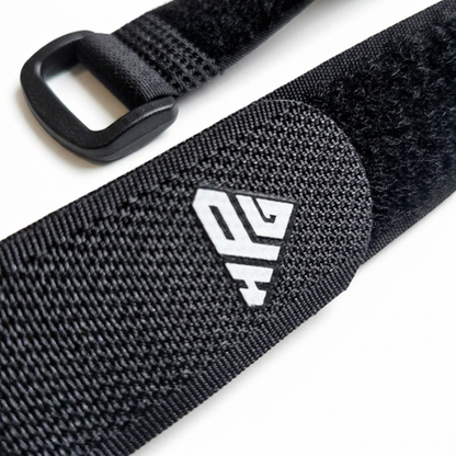 Close-up of a Clinch Band Storage Strap showing the hook and loop surface and the plastic buckle loop end