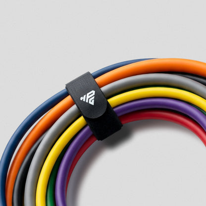 Clinch Band Storage Strap wrapped around a coiled set of colour-coded HomeProGym bands.