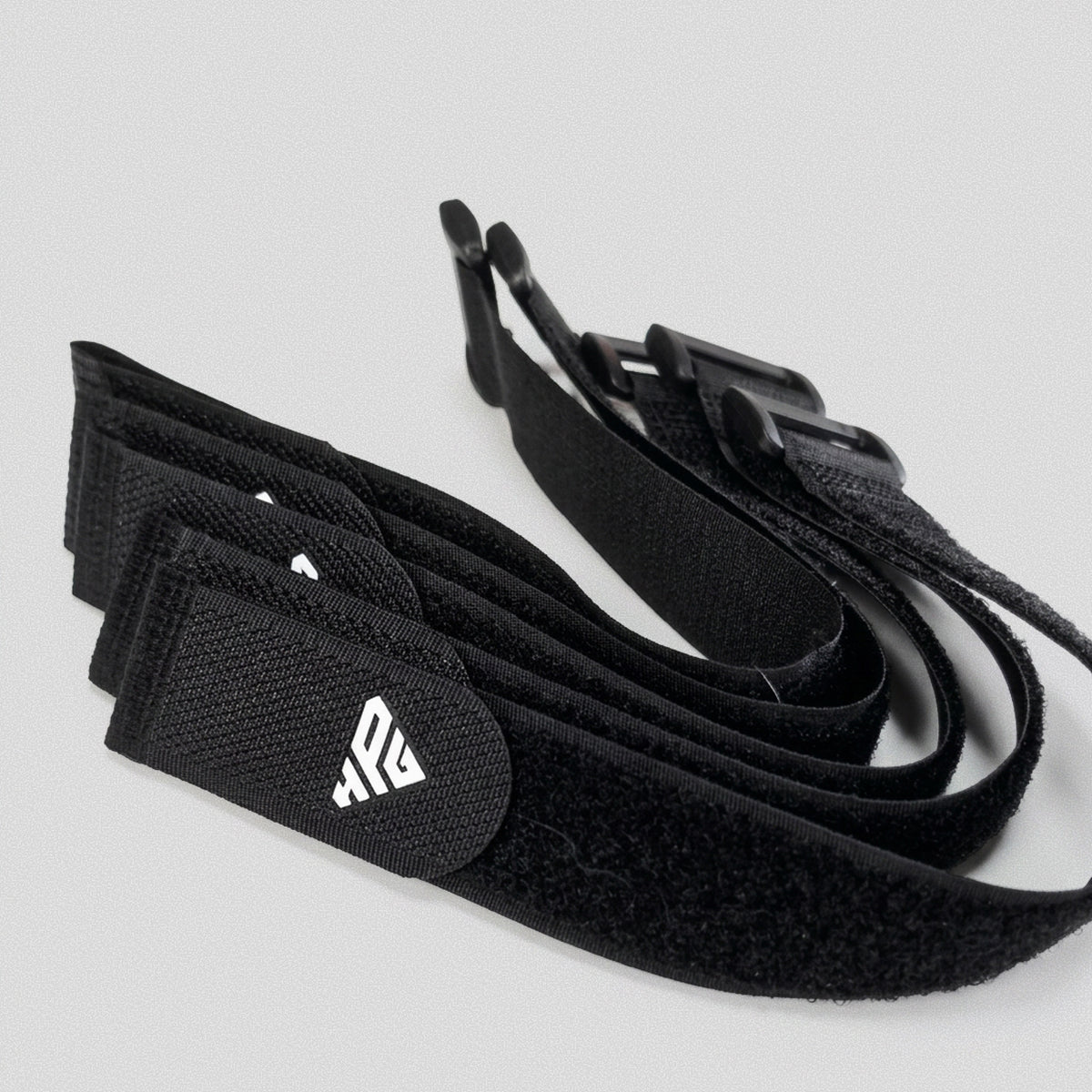 Several Clinch Straps stacked, showing the buckles and HomeProGym logo.