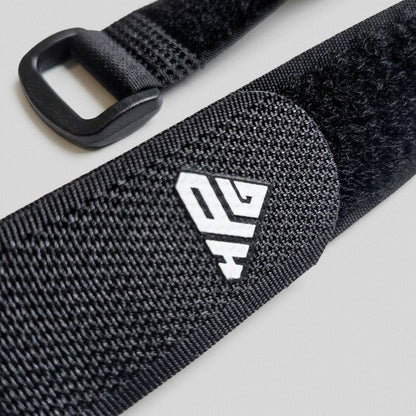 Buckle and hook-and-loop surface of the Clinch Band Storage Strap with the HomeProGym logo.