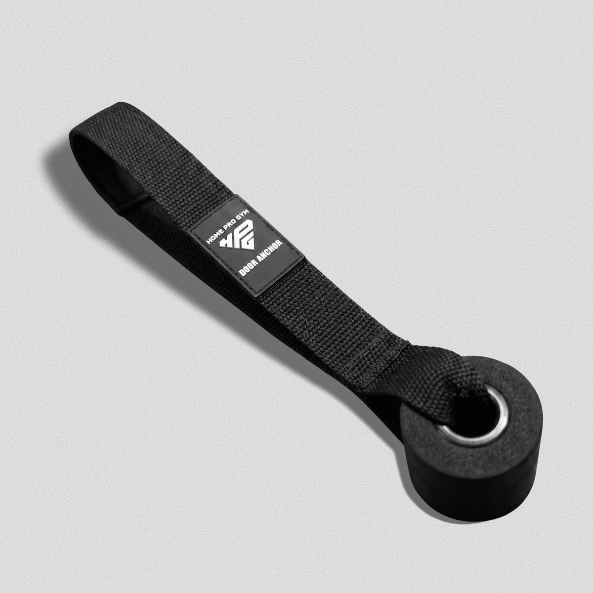 Door Anchor laid flat, showing the strap loop, HomeProGym label and foam stopper.