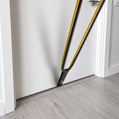 Door Anchor fitted under the bottom of a door with a band running up from it.