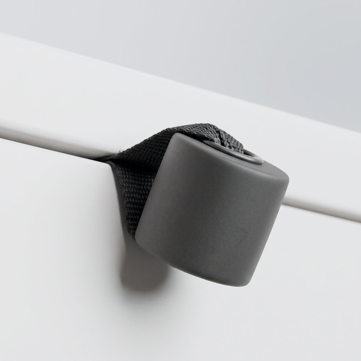 Foam stopper of the Door Anchor seated against the far side of a door edge.