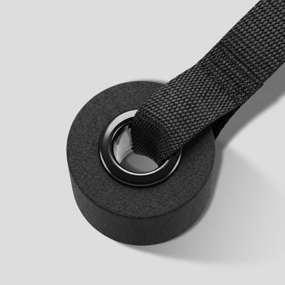 Foam stopper and steel grommet of the Door Anchor with the strap threaded through.