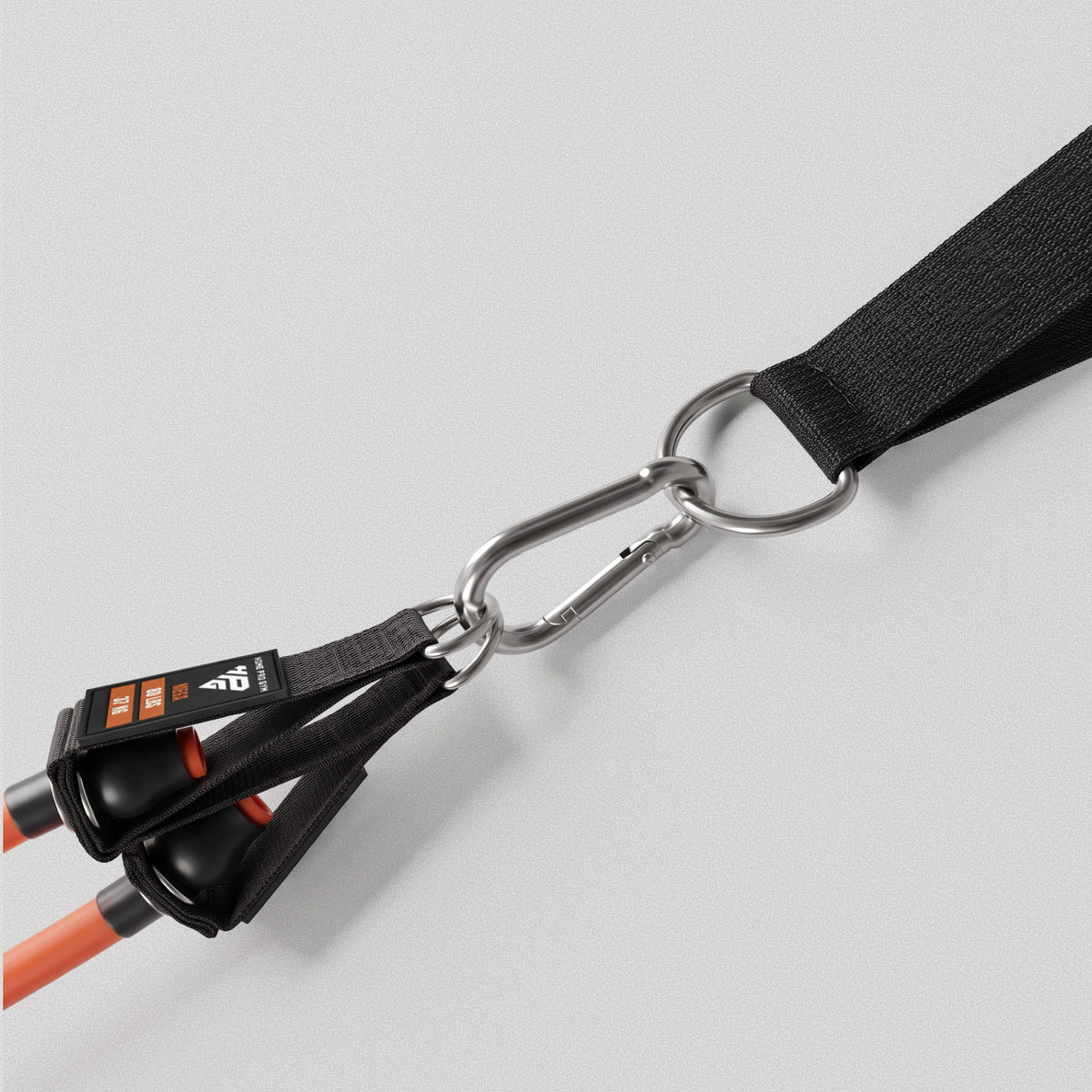 Carabiner linking two bands to a HomeProGym anchor strap.