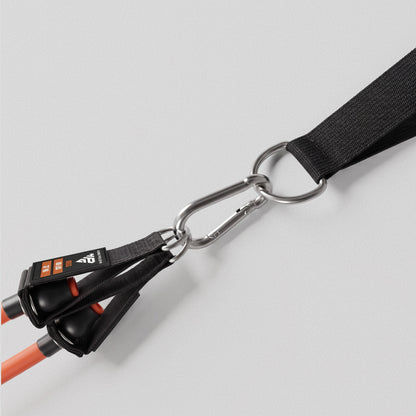 Carabiner linking two bands to a HomeProGym anchor strap.