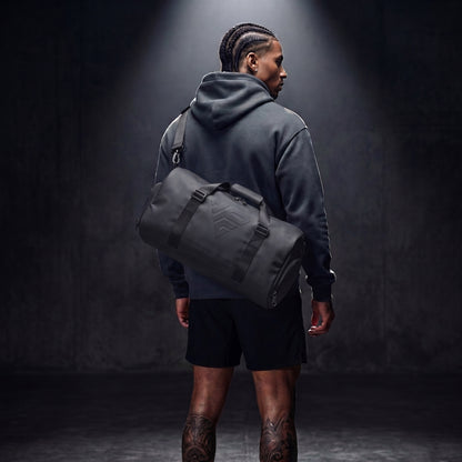 GymRoam 30L Duffle Bag carried on the shoulder by the strap, seen from behind.