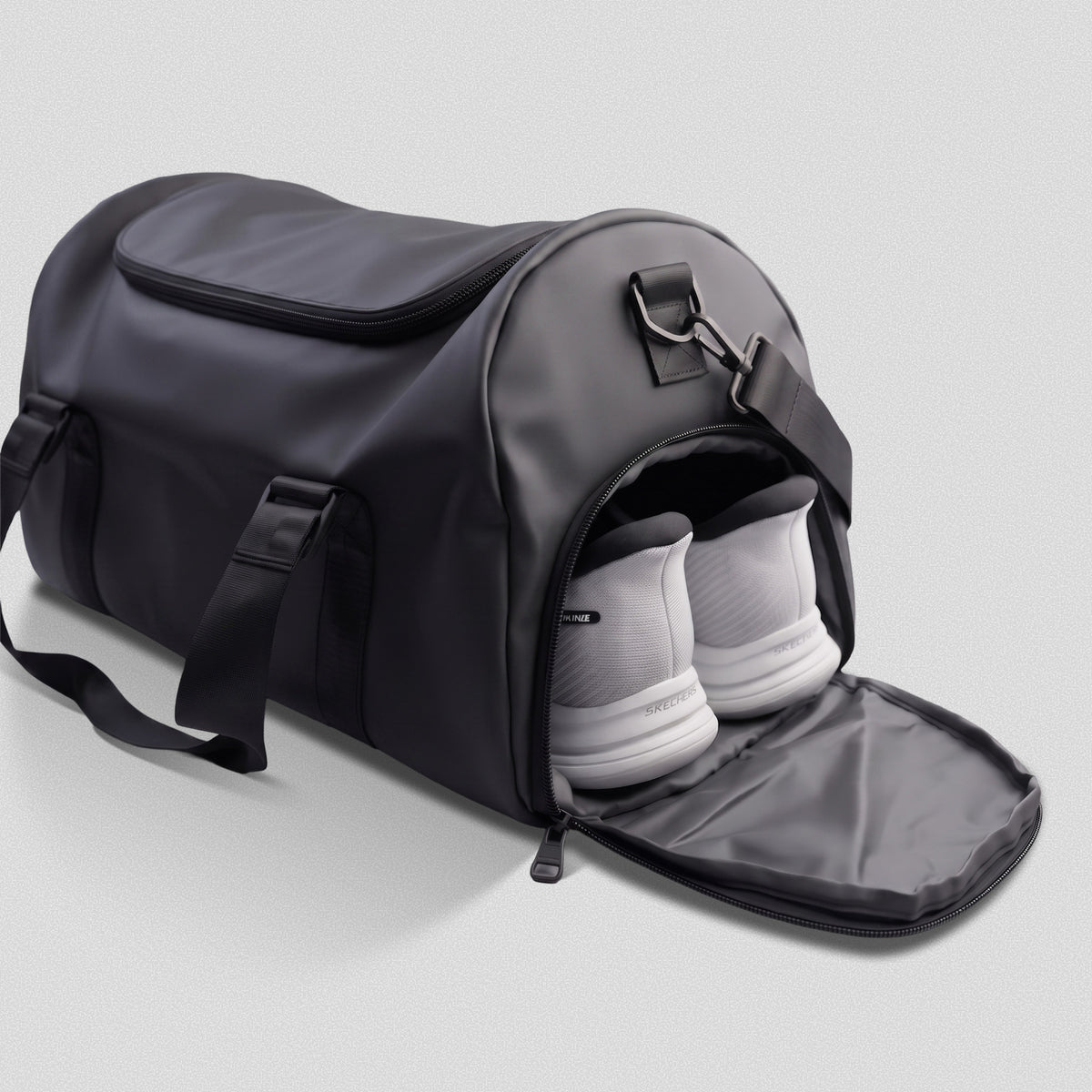 Side shoe compartment of the GymRoam 30L Duffle Bag unzipped with a pair of trainers inside.