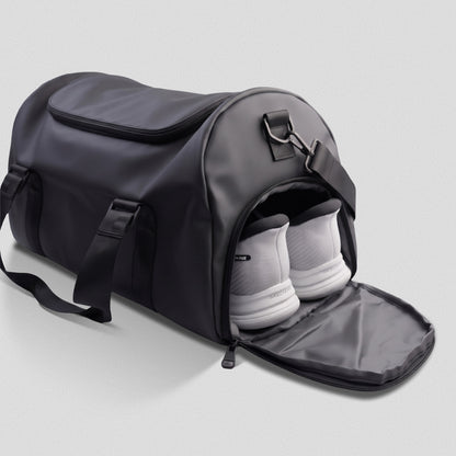 Side shoe compartment of the GymRoam 30L Duffle Bag unzipped with a pair of trainers inside.