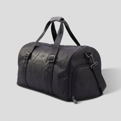 Water beading on the coated fabric of the GymRoam 30L Duffle Bag.