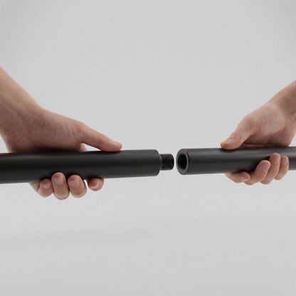 Hands screwing the two halves of the Resistance Band Bar together at the threaded joint.