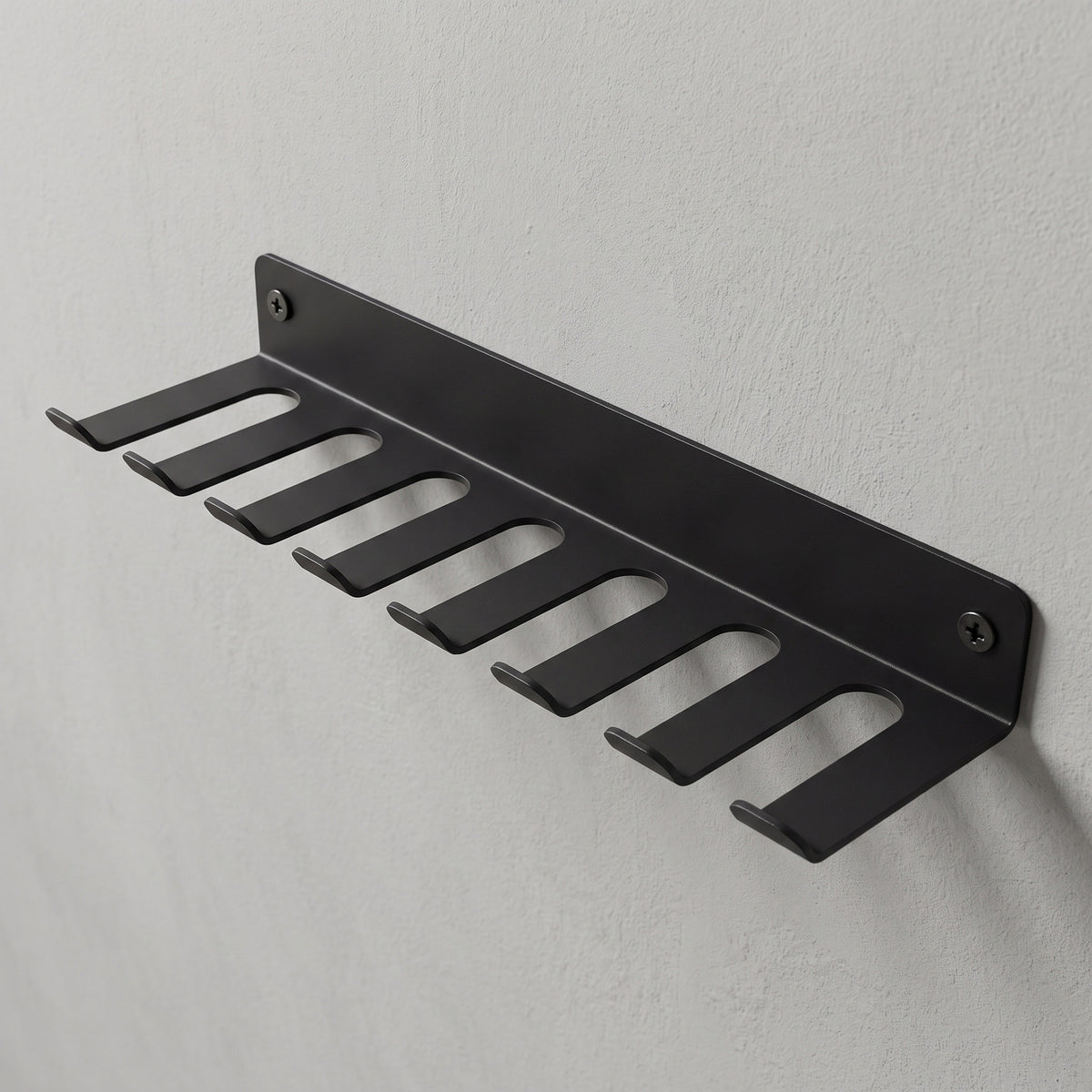 Storage Rack screwed to a wall, hooks facing out.