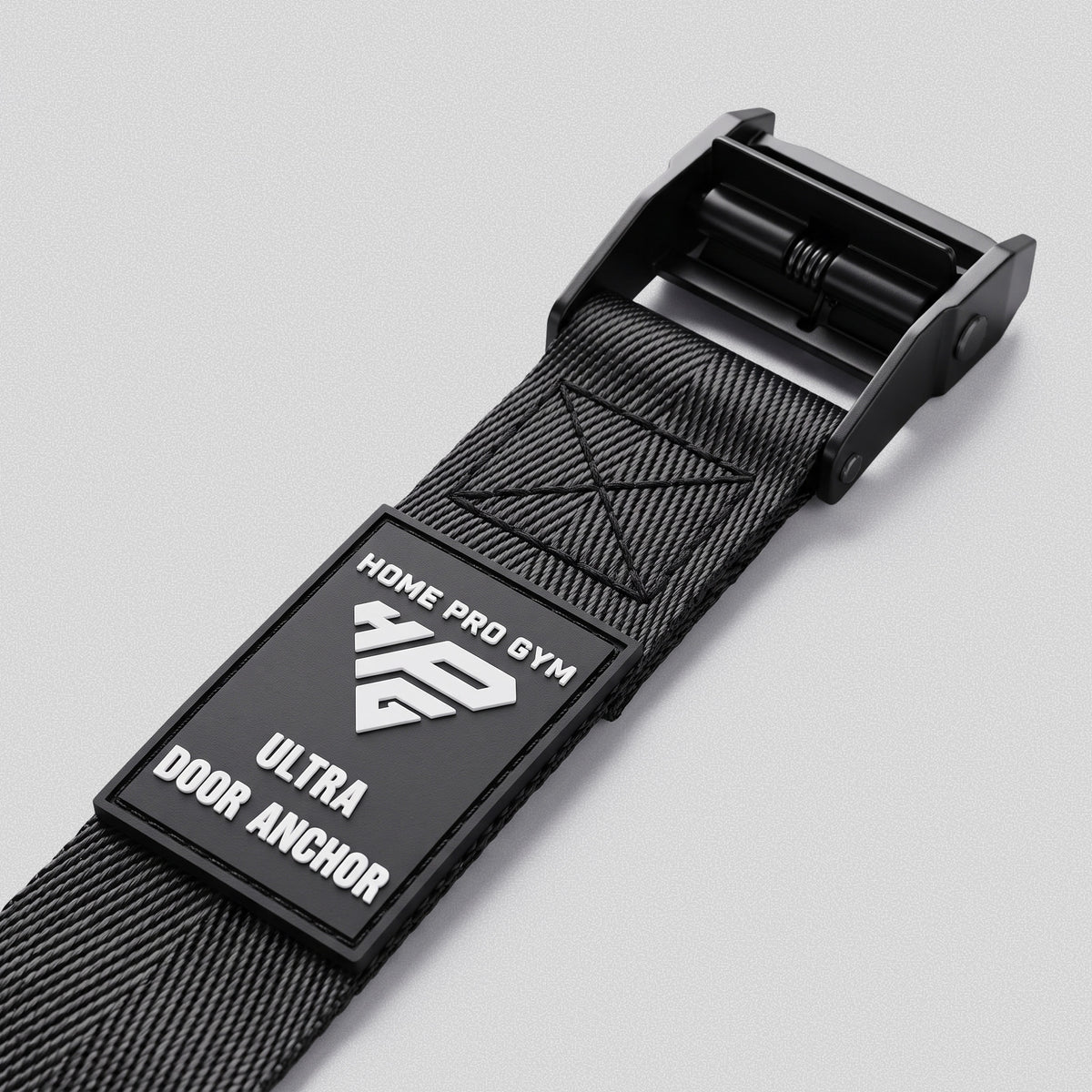 Rubber HomeProGym Ultra Door Anchor label on the strap, next to the cam buckle.