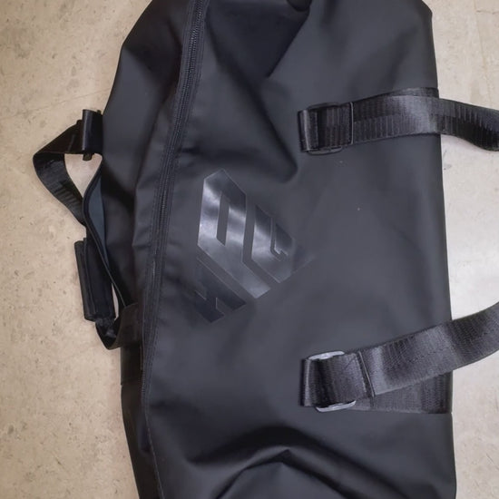 Video: hands packing the GymRoam 30L Duffle Bag and opening its side compartment