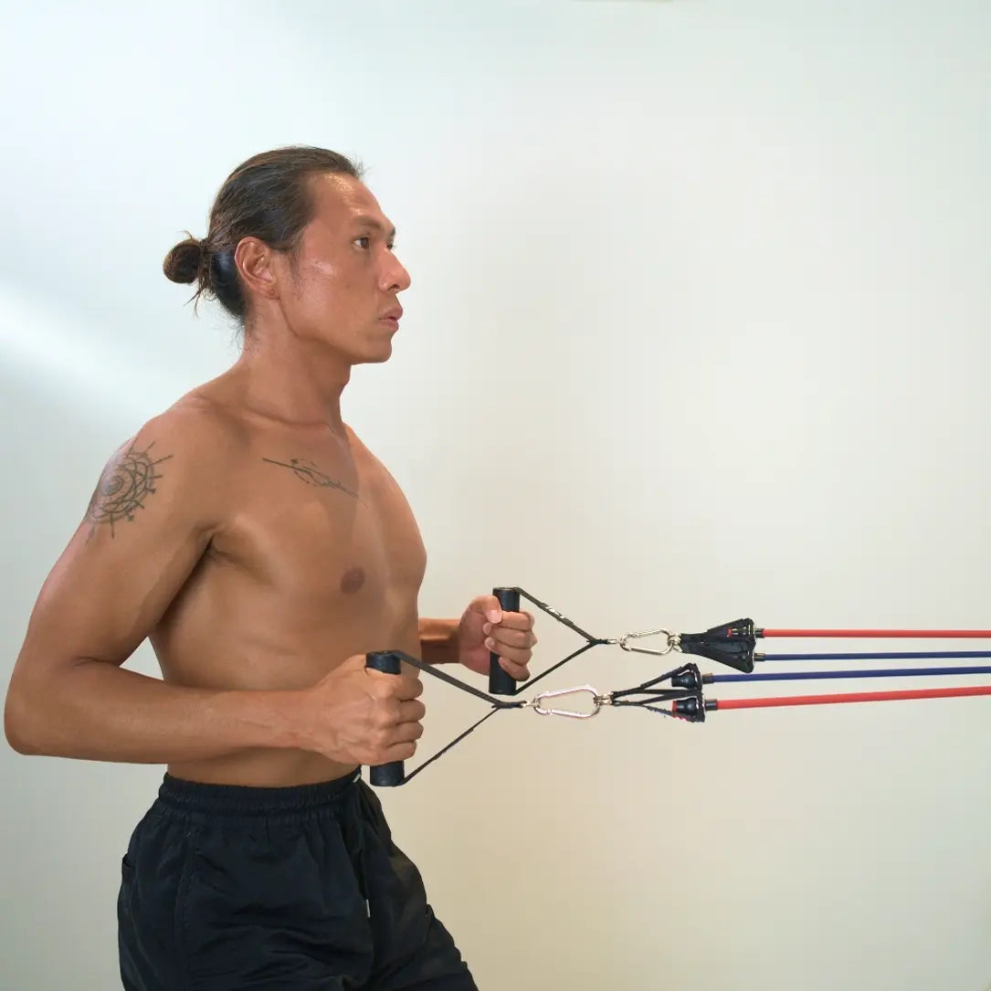Man performing back rows exercise with HomeProGym PowerTube stackable resistance bands at home